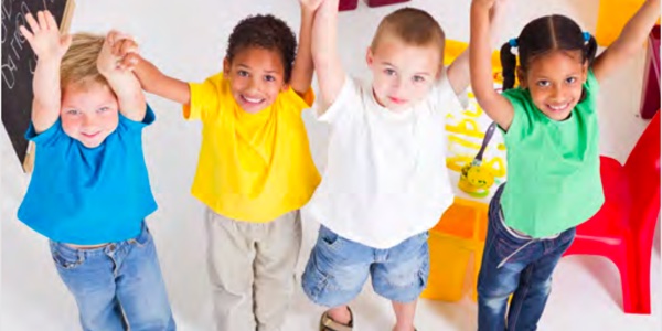 small group of children holding hands with arms in the air